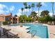 Inviting pool area with lounge chairs, clear blue water, and lush landscaping, perfect for relaxation and recreation at 221 Mission Catalina Ln # 202, Las Vegas, NV 89107