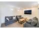 Inviting sitting area featuring comfortable sofas, stylish cushions, and a sleek coffee table, ideal for relaxation and conversation at 221 Mission Catalina Ln # 202, Las Vegas, NV 89107
