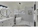 Bright bathroom featuring a single sink vanity, soaking tub, and modern fixtures with recessed lighting at 239 Highgate St, Henderson, NV 89074