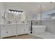 Bright bathroom featuring a dual sink vanity, soaking tub, and modern fixtures with recessed lighting at 239 Highgate St, Henderson, NV 89074