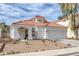 Charming single-story home with a red tile roof, white exterior, and desert landscaping at 239 Highgate St, Henderson, NV 89074