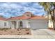 Charming single-story home featuring a red tile roof, two-car garage, and low-maintenance landscaping at 239 Highgate St, Henderson, NV 89074