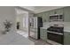 Modern kitchen with stainless steel appliances, light countertops and painted green cabinets at 239 Highgate St, Henderson, NV 89074