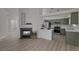 Open-concept living room with fireplace and updated kitchen and breakfast bar at 239 Highgate St, Henderson, NV 89074