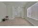 Open living area with light wood flooring, large windows, and neutral paint at 239 Highgate St, Henderson, NV 89074