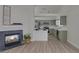 Open-concept living room with wood-look floors, fireplace, and an updated kitchen at 239 Highgate St, Henderson, NV 89074