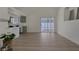 Open-concept living room with wood-look floors and sliding doors to the patio at 239 Highgate St, Henderson, NV 89074