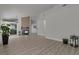 Spacious living room featuring wood-look floors, fireplace, and view into the kitchen at 239 Highgate St, Henderson, NV 89074