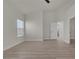 Spacious main bedroom with wood-look floors and adjoining bathroom and closet at 239 Highgate St, Henderson, NV 89074