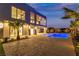 The beautifully landscaped backyard has a pristine pool and elegant patio space for entertaining in luxury at 2827 Richmar Ave, Henderson, NV 89074