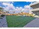 Lush backyard featuring new grass and well-maintained landscaping and mature trees at 2827 Richmar Ave, Henderson, NV 89074