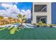 Modern home boasts a luxurious backyard with a pool, lush turf, and desert landscaping at 2827 Richmar Ave, Henderson, NV 89074
