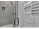 Contemporary bathroom showcasing a walk-in glass shower and closet with white built-in shelves at 2827 Richmar Ave, Henderson, NV 89074