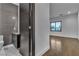 Modern bathroom boasts gray tile walls, floating vanity, and wood-look flooring at 2827 Richmar Ave, Henderson, NV 89074