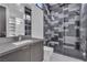 Modern bathroom featuring a dual vanity, walk-in shower with tile accents and a closet at 2827 Richmar Ave, Henderson, NV 89074