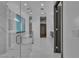 Hallway view to bathroom featuring glass enclosed shower and tub at 2827 Richmar Ave, Henderson, NV 89074