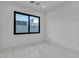 Minimalist bedroom with large windows providing natural light and a view of the neighborhood at 2827 Richmar Ave, Henderson, NV 89074