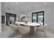 Contemporary dining room with sleek table, modern chairs, and a view of the backyard at 2827 Richmar Ave, Henderson, NV 89074