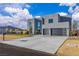 Contemporary two-story home with desert landscaping, concrete driveway, and a stylish black garage door at 2827 Richmar Ave, Henderson, NV 89074