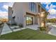 Modern home features desert landscaping, a water feature, and concrete pavers with green spaces at 2827 Richmar Ave, Henderson, NV 89074