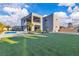 Stunning modern home showcases a backyard oasis with pool, landscaping and green turf at 2827 Richmar Ave, Henderson, NV 89074