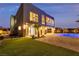 Contemporary two-story home boasts a private backyard with a sparkling blue pool and ample outdoor lighting at 2827 Richmar Ave, Henderson, NV 89074
