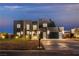 Modern home shines at dusk with a three-car garage and manicured landscaping at 2827 Richmar Ave, Henderson, NV 89074