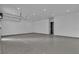 Three car garage showcases epoxy flooring, lift access and ample space at 2827 Richmar Ave, Henderson, NV 89074