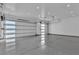 Spacious three car garage featuring recessed lighting and epoxy flooring at 2827 Richmar Ave, Henderson, NV 89074