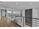 Open hallway features wood floors, modern railing and fireplace accent wall at 2827 Richmar Ave, Henderson, NV 89074