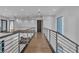 Modern hallway with hardwood floors and metal railings, showcasing contemporary design and open space at 2827 Richmar Ave, Henderson, NV 89074