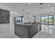 Spacious kitchen with an island, modern appliances, and large sliding glass doors leading outside at 2827 Richmar Ave, Henderson, NV 89074