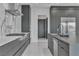 Modern kitchen featuring a sleek cooktop, marble backsplash, and stainless steel appliances at 2827 Richmar Ave, Henderson, NV 89074