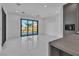 Bright living room with white tile floors and a sliding glass door to the backyard at 2827 Richmar Ave, Henderson, NV 89074
