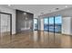 Bright living room features hardwood floors, a modern fireplace, and expansive windows with city views at 2827 Richmar Ave, Henderson, NV 89074