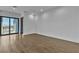 Spacious living room with hardwood floors and access to a balcony with mountain views at 2827 Richmar Ave, Henderson, NV 89074