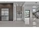 Modern living area featuring a glass-enclosed wine rack, stainless steel fridge, and sleek design at 2827 Richmar Ave, Henderson, NV 89074