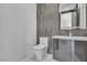 Sleek powder room with modern fixtures, gray tile, and a floating vanity at 2827 Richmar Ave, Henderson, NV 89074