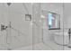 Modern bathroom shower with glass enclosure, window and tile at 2827 Richmar Ave, Henderson, NV 89074