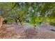 Landscaped backyard with gravel, mature trees and privacy hedges at 3032 Stratmoor Hills Ave, Henderson, NV 89052