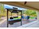 Backyard patio featuring a grill, bar seating, and a gazebo with outdoor furniture at 3032 Stratmoor Hills Ave, Henderson, NV 89052