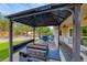 Backyard patio featuring a grill, bar seating, and a gazebo with outdoor furniture at 3032 Stratmoor Hills Ave, Henderson, NV 89052
