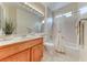 Bright bathroom featuring a shower-over-tub combo and a stylish wood vanity at 3032 Stratmoor Hills Ave, Henderson, NV 89052