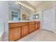 Well-lit bathroom with double sinks, a large mirror, and ample storage space at 3032 Stratmoor Hills Ave, Henderson, NV 89052