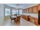 Eat-in kitchen features wooden cabinets and a sunlit dining nook at 3032 Stratmoor Hills Ave, Henderson, NV 89052