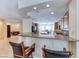 Open-concept kitchen featuring granite countertops and seamless flow into the dining room and bar area at 3032 Stratmoor Hills Ave, Henderson, NV 89052