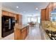 Open kitchen with stainless steel appliances, granite countertops, kitchen island, and eat-in dining area at 3032 Stratmoor Hills Ave, Henderson, NV 89052