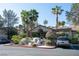 Inviting clubhouse entrance with mature trees and landscaping, creating a welcoming atmosphere at 3145 E Flamingo Rd # 2119, Las Vegas, NV 89121