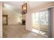 Open concept space showcases patio doors, a modern light fixture and views into the living room at 3145 E Flamingo Rd # 2119, Las Vegas, NV 89121