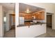 Efficient kitchen featuring wood cabinets, white appliances, and a breakfast bar for additional seating at 3145 E Flamingo Rd # 2119, Las Vegas, NV 89121